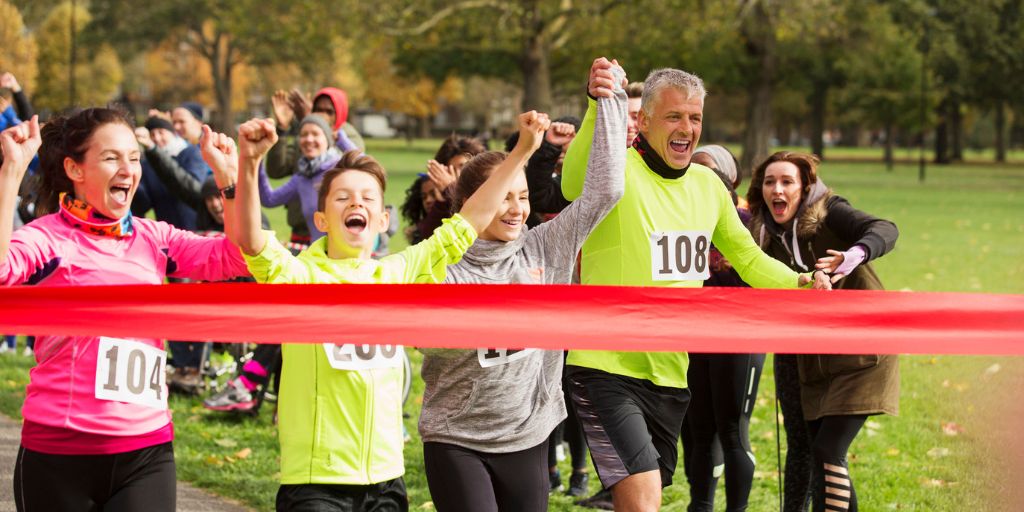 Family finishing a race together and celebrating