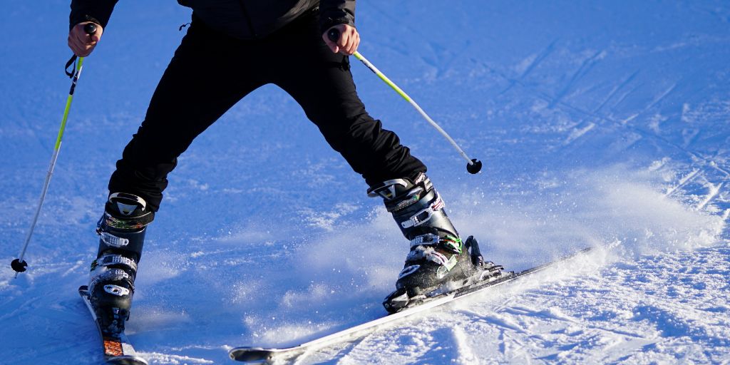 Skier snowplowing down a slope